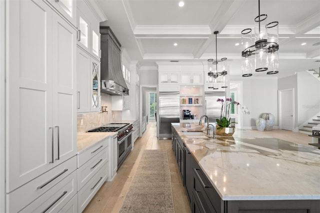 kitchen featuring pendant lighting, premium appliances, and white cabinetry