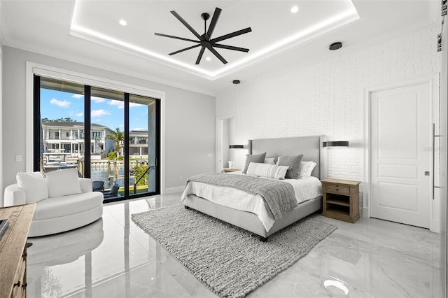 bedroom featuring crown molding, a tray ceiling, and access to outside