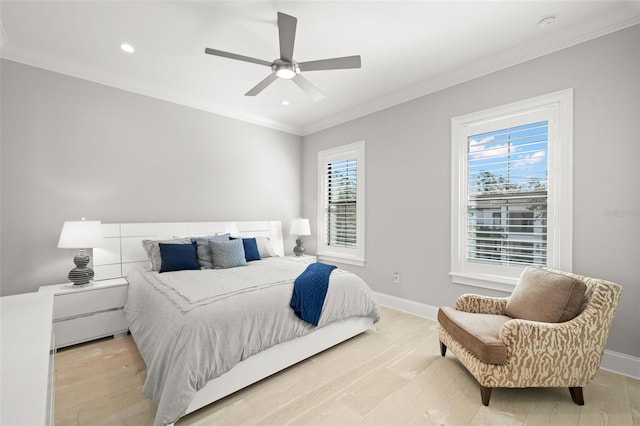 bedroom featuring multiple windows, crown molding, and light hardwood / wood-style flooring