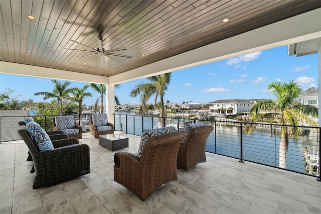 view of patio / terrace featuring a water view, an outdoor hangout area, and ceiling fan