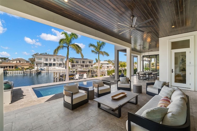 view of patio / terrace featuring an outdoor living space, ceiling fan, and a water view