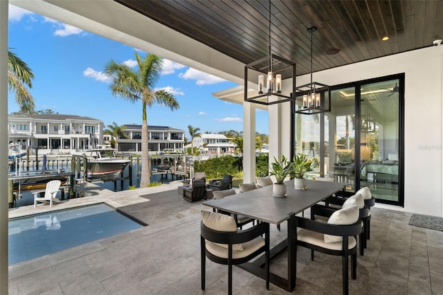 view of patio / terrace featuring a water view and a boat dock