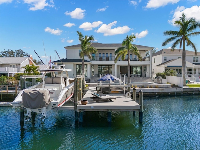 dock area featuring a balcony and a water view