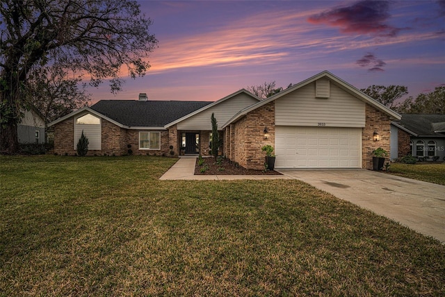 single story home with a garage and a lawn