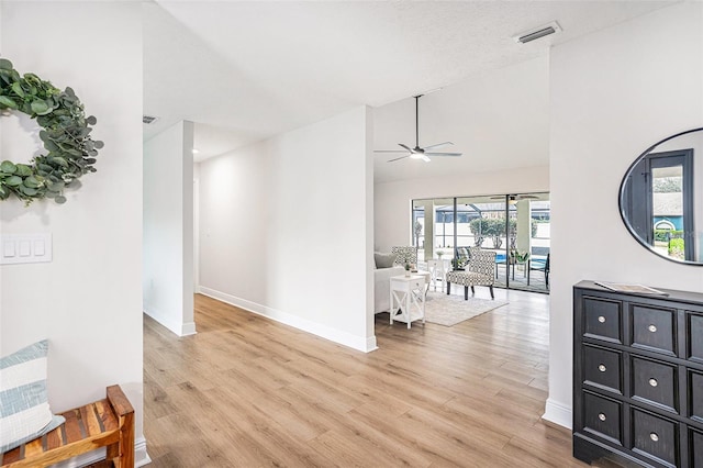 interior space with lofted ceiling and light wood-type flooring