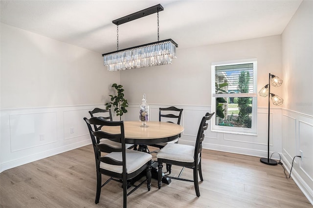 dining room featuring an inviting chandelier and light wood-type flooring