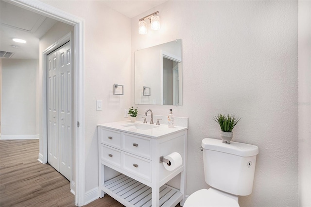 bathroom featuring hardwood / wood-style flooring, vanity, and toilet