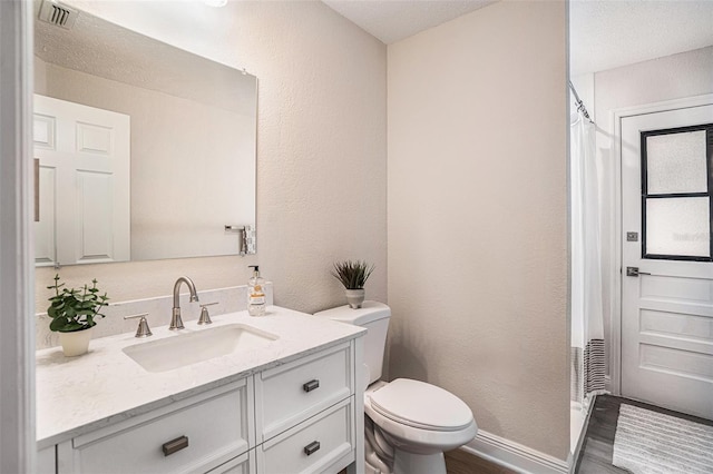 bathroom with vanity, hardwood / wood-style floors, a shower with shower curtain, and toilet