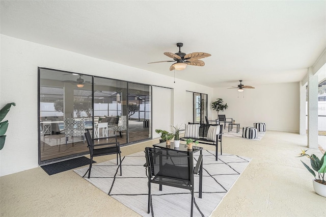 carpeted living room with ceiling fan