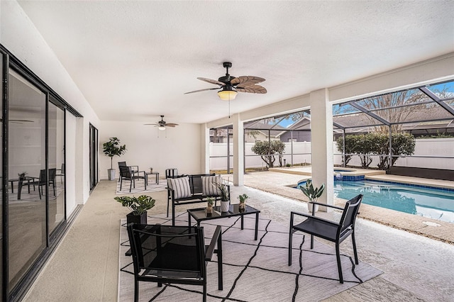 view of patio with ceiling fan, a lanai, and a fenced in pool