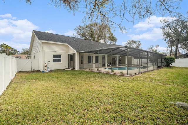 back of property with a fenced in pool, a patio, and a yard