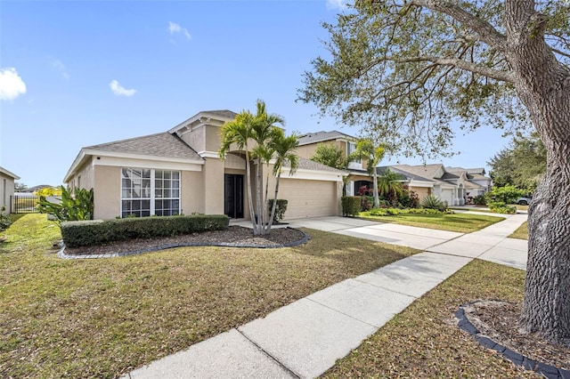 ranch-style home with a garage and a front lawn