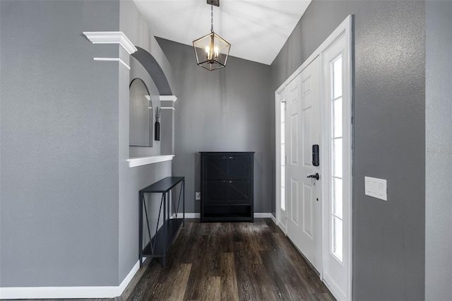 entryway with dark hardwood / wood-style floors and a notable chandelier