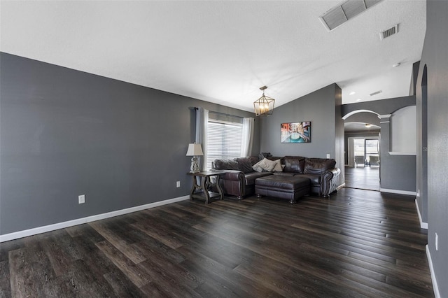 living room featuring dark hardwood / wood-style flooring and vaulted ceiling