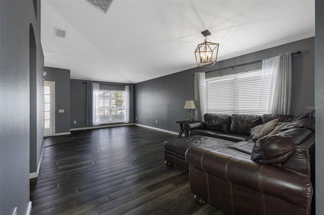 living room with a chandelier and dark hardwood / wood-style flooring