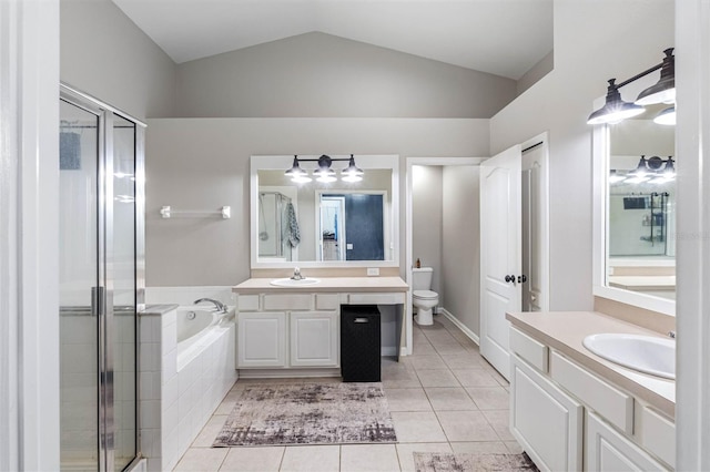 full bathroom featuring shower with separate bathtub, lofted ceiling, vanity, toilet, and tile patterned floors