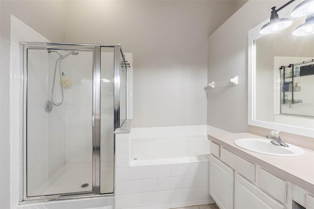 bathroom featuring vanity and separate shower and tub