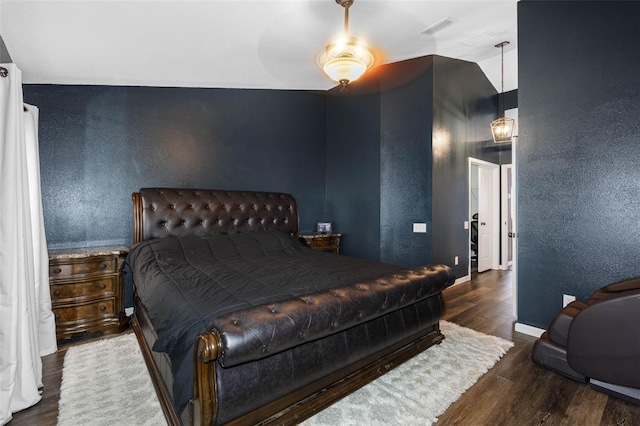 bedroom featuring ceiling fan, lofted ceiling, and dark hardwood / wood-style flooring