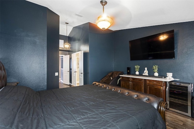 bedroom with wine cooler and dark hardwood / wood-style flooring