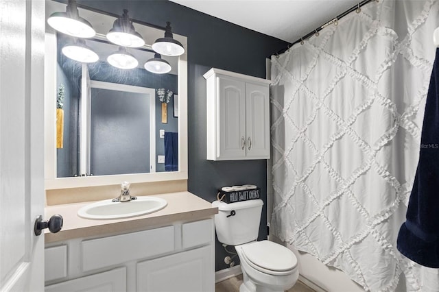 full bathroom with vanity, shower / tub combo, and toilet