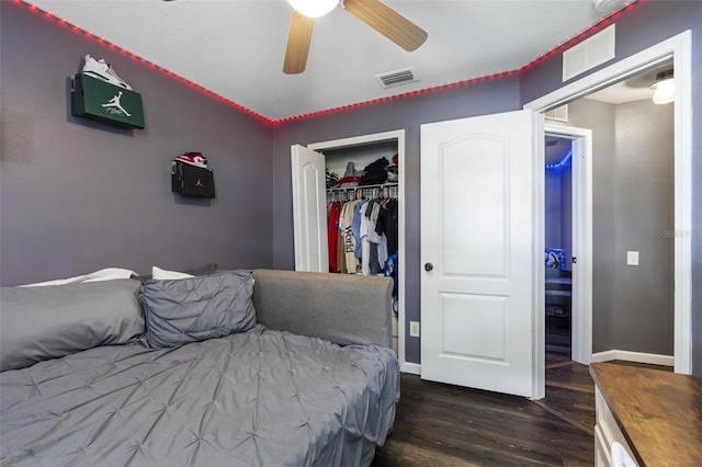 bedroom with dark hardwood / wood-style flooring, a closet, and ceiling fan