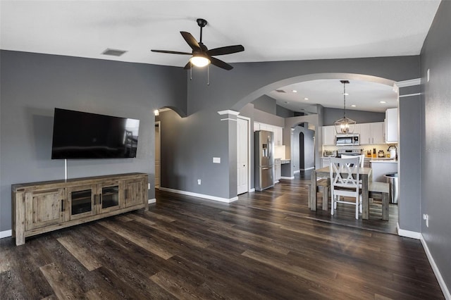 unfurnished living room with lofted ceiling, dark wood-type flooring, and ceiling fan