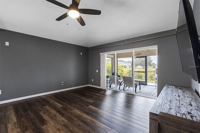 unfurnished living room featuring dark hardwood / wood-style floors and ceiling fan