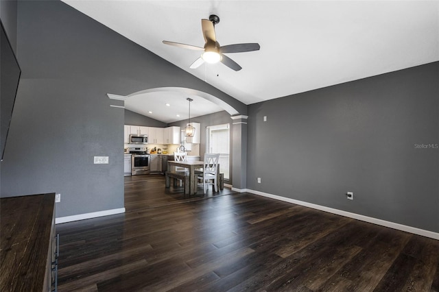 unfurnished dining area with ceiling fan, lofted ceiling, and dark hardwood / wood-style flooring