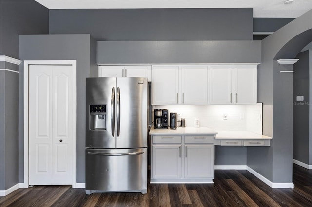 kitchen with dark hardwood / wood-style floors, white cabinets, backsplash, and stainless steel fridge with ice dispenser