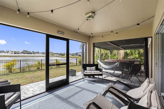 sunroom / solarium with a water view