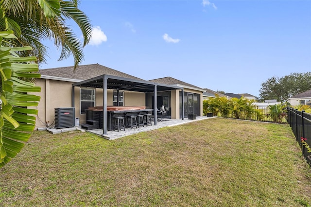 back of property with a yard, cooling unit, a patio area, and a bar