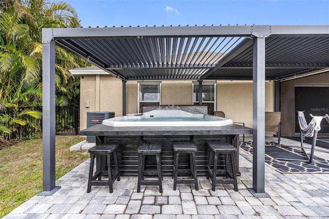 view of patio / terrace with cooling unit and an outdoor bar