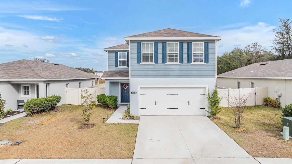 view of front of home with a garage and a front yard