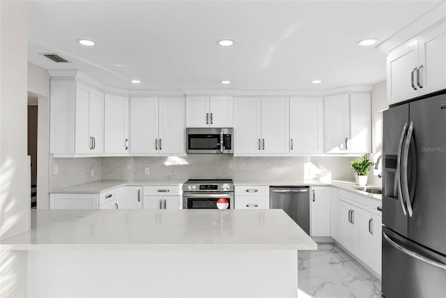 kitchen with appliances with stainless steel finishes and white cabinets