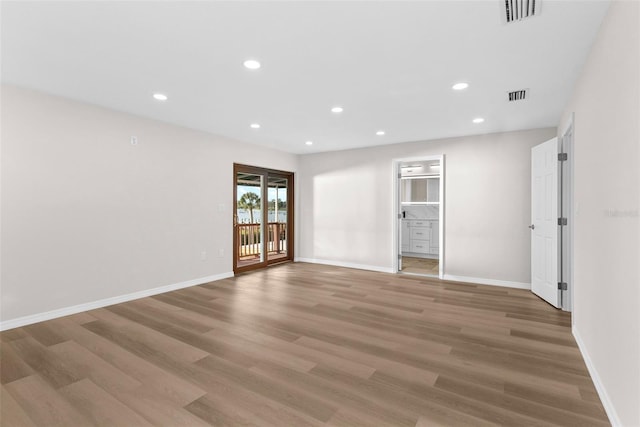 spare room featuring light wood-type flooring