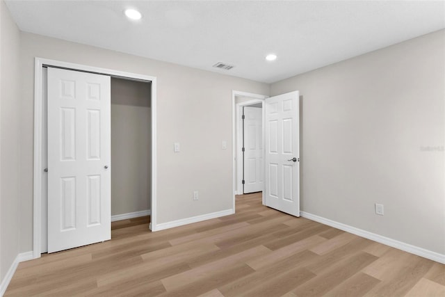 unfurnished bedroom featuring baseboards, recessed lighting, visible vents, and light wood-style floors