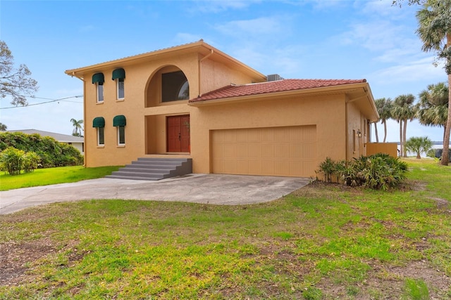 mediterranean / spanish-style home featuring an attached garage, driveway, a tiled roof, stucco siding, and a front lawn