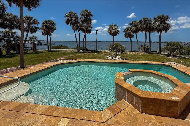 316 Shore Dr E, Oldsmar, FL 34677 - view of pool featuring a yard, a water view, and a pool with connected hot tub