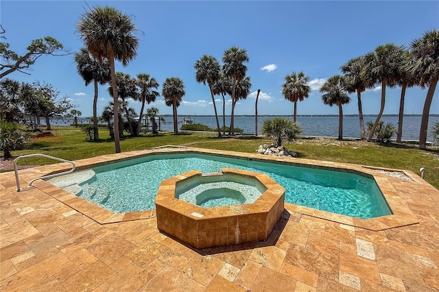 316 Shore Dr E, Oldsmar, FL 34677 - view of swimming pool featuring a patio, a water view, a lawn, and a pool with connected hot tub
