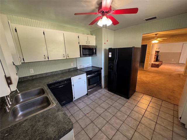 kitchen with sink, ceiling fan, white cabinetry, black appliances, and light tile patterned flooring