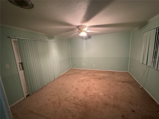 spare room featuring ceiling fan, carpet floors, and a textured ceiling