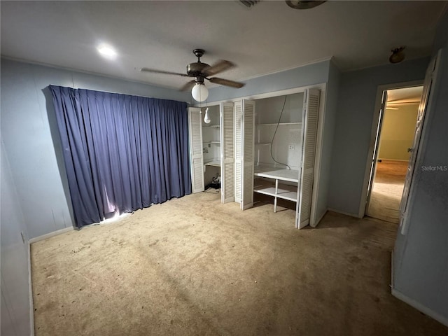 unfurnished bedroom with carpet floors and ceiling fan