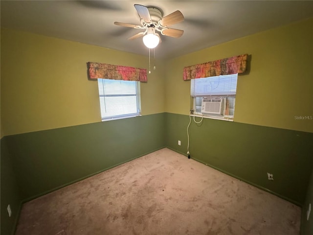 carpeted spare room featuring cooling unit and ceiling fan