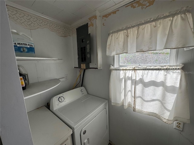 washroom with ornamental molding, separate washer and dryer, and electric panel