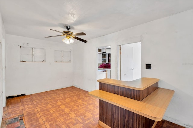 spare room with parquet floors and ceiling fan