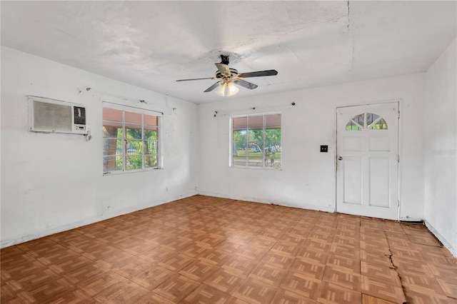 interior space featuring parquet flooring, an AC wall unit, and ceiling fan