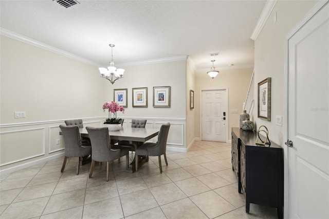 tiled dining space with ornamental molding and a notable chandelier