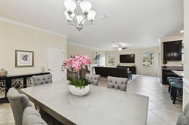 dining room featuring ornamental molding, ceiling fan with notable chandelier, and light tile patterned floors