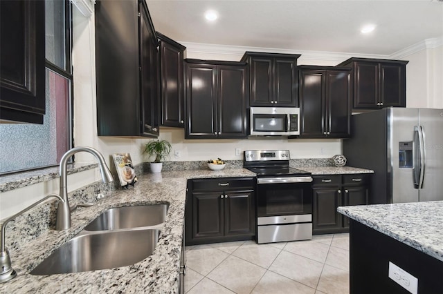 kitchen featuring light tile patterned flooring, sink, ornamental molding, stainless steel appliances, and light stone countertops