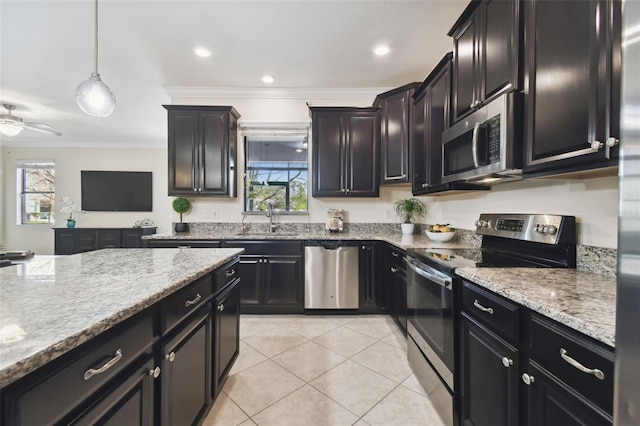 kitchen with sink, light tile patterned floors, appliances with stainless steel finishes, ornamental molding, and decorative light fixtures